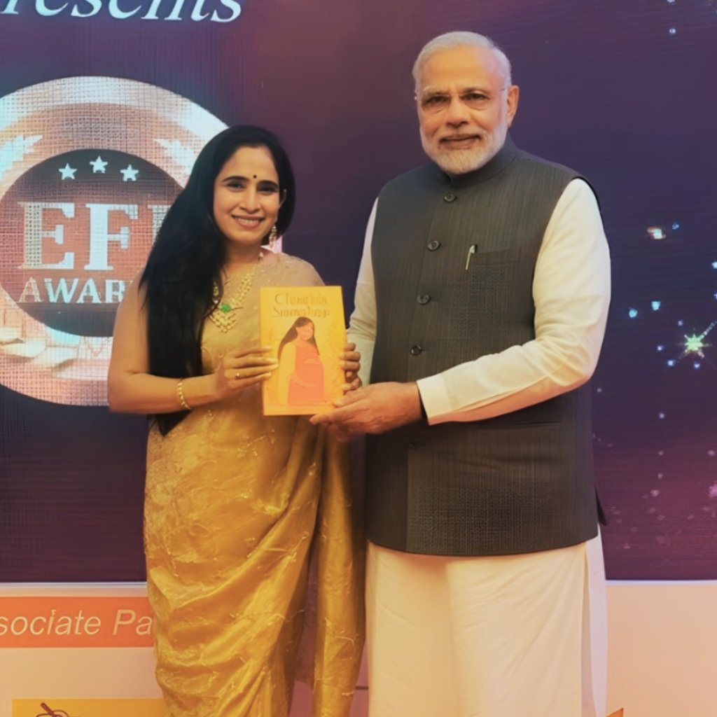 Dr. Sandya Dsilva presenting book to Prime Minister Narendra Modi